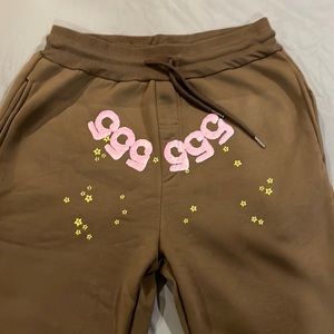 Brand is Spyder, mens medium sweatpants. Brown with yellow stars.
